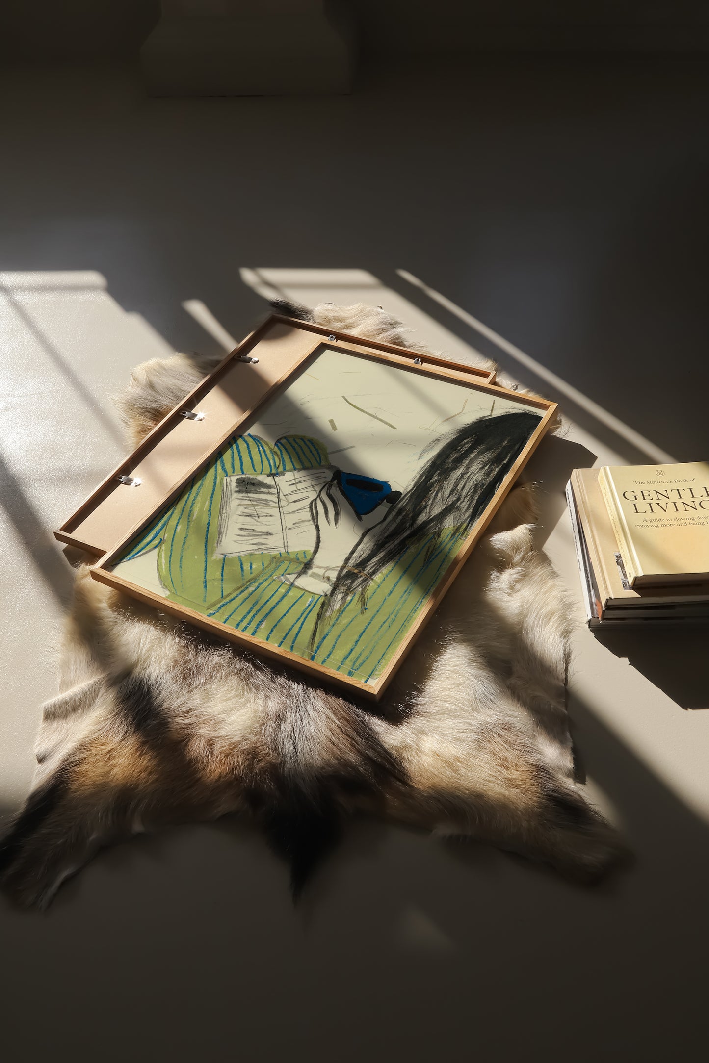 Illustration of a girl wearing a striped pyjama, reading a book and drinking out of a blue mug.