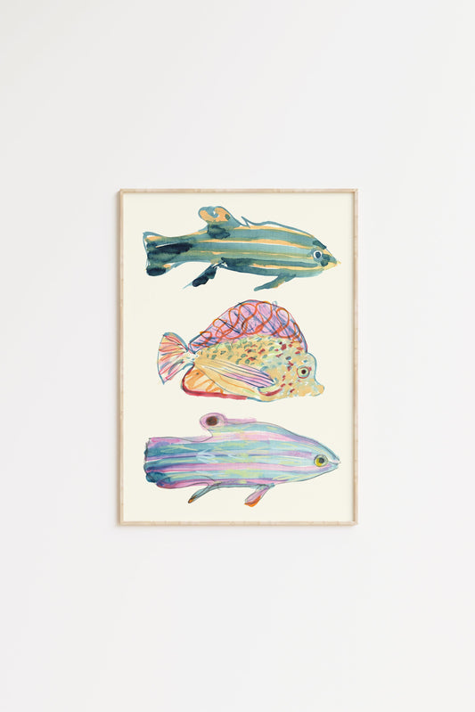 Framed artwork of three colorful fish on a ivory background