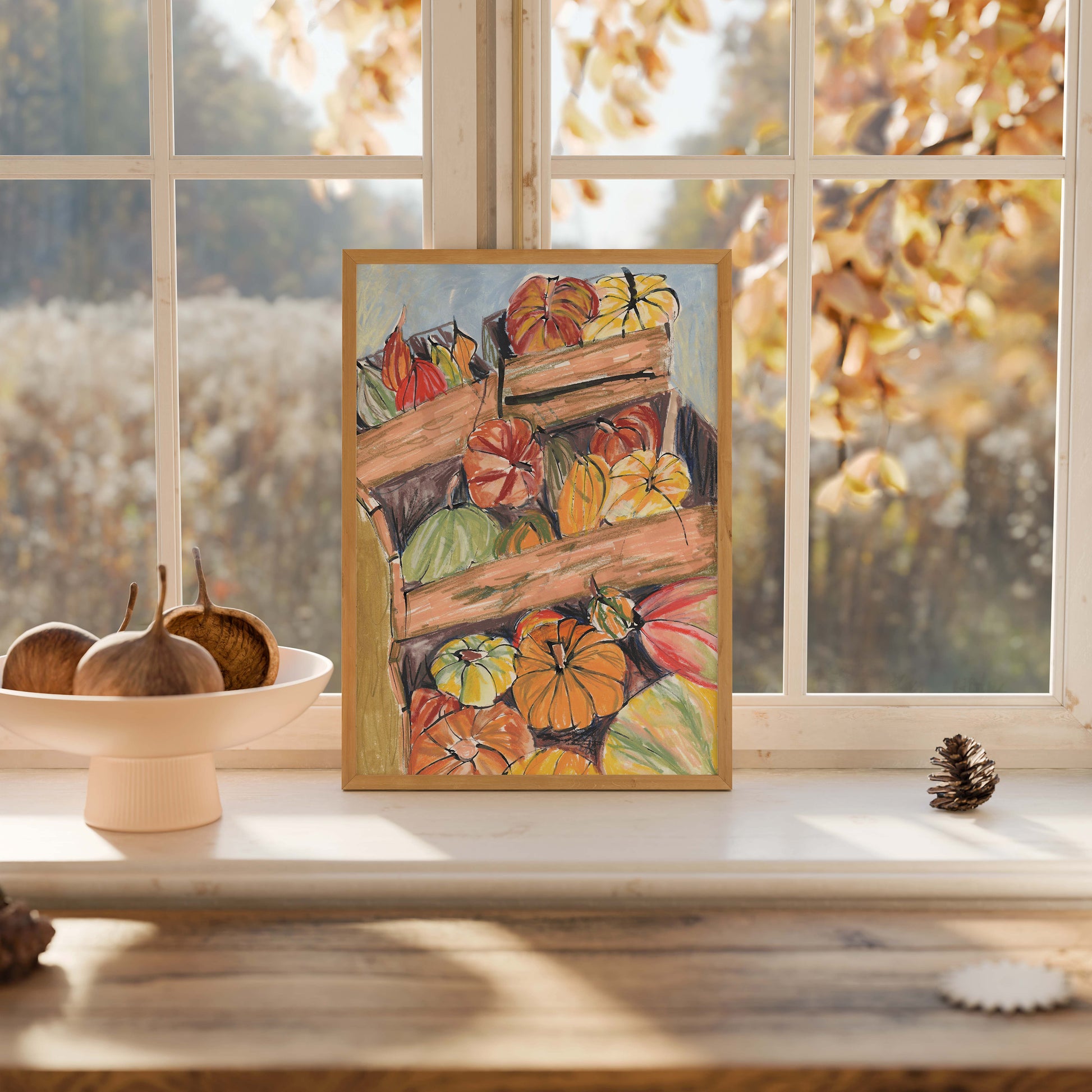 Framed painting of pumpkins on a windowsill with autumn leaves outside