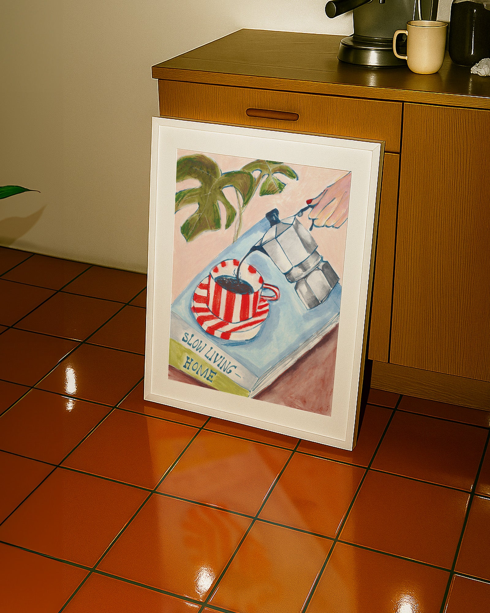 Framed artwork on a kitchen counter with tiled floor