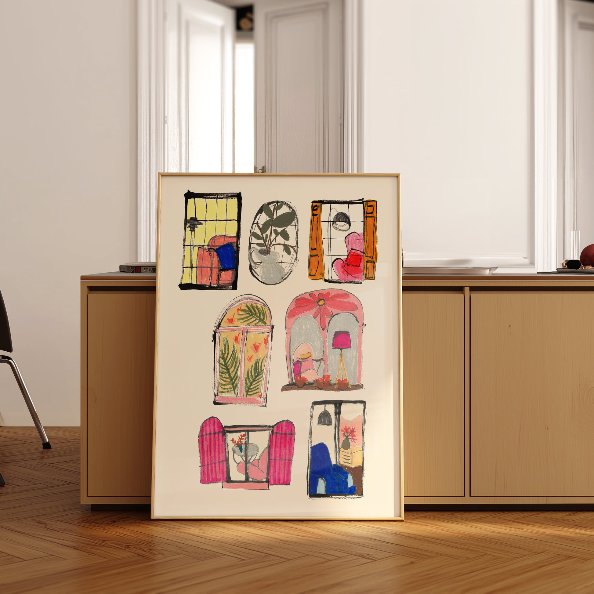 Framed artwork with colorful door illustrations on a wooden floor.