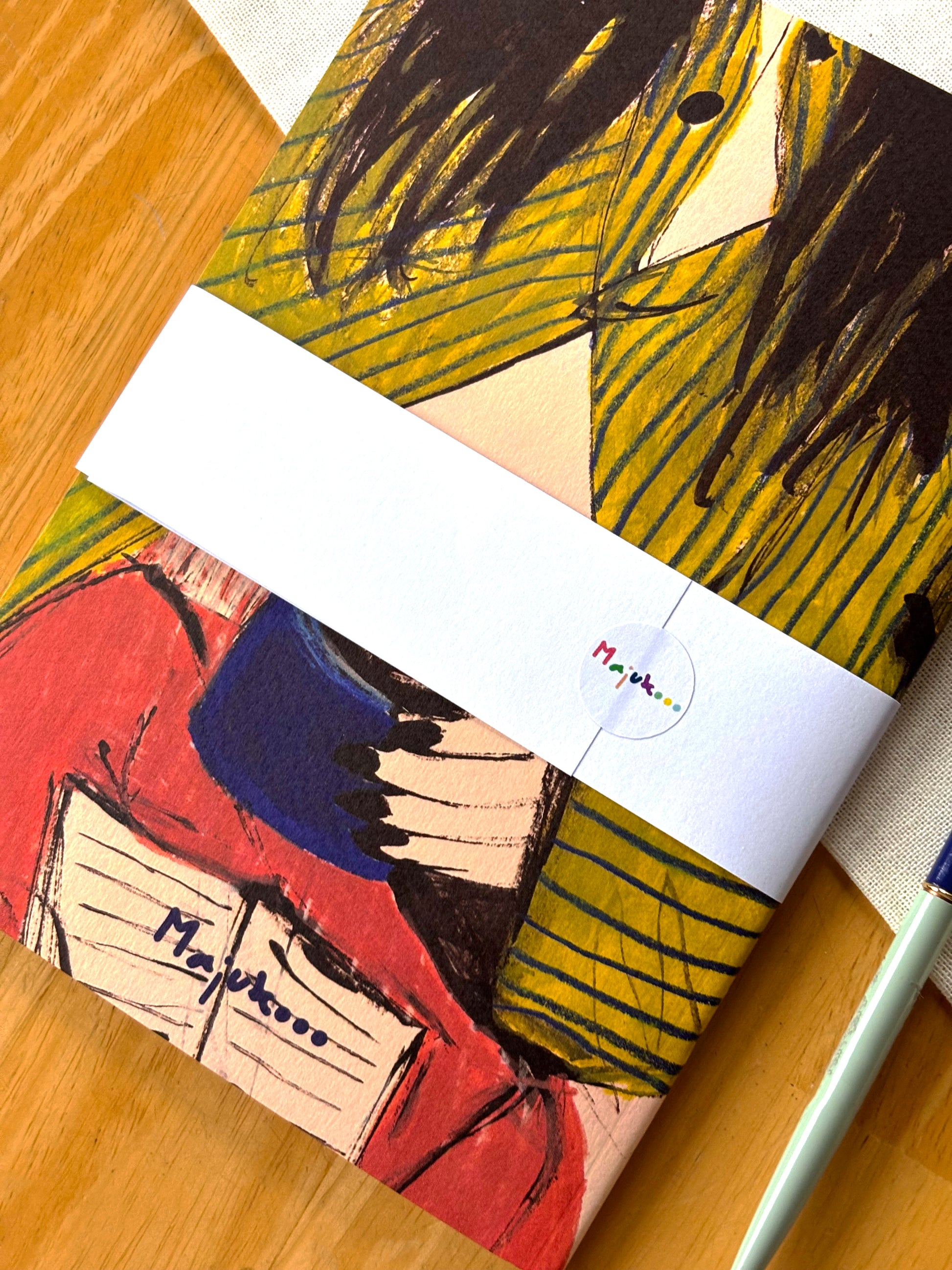 Colorful notebook with artistic design on a wooden surface