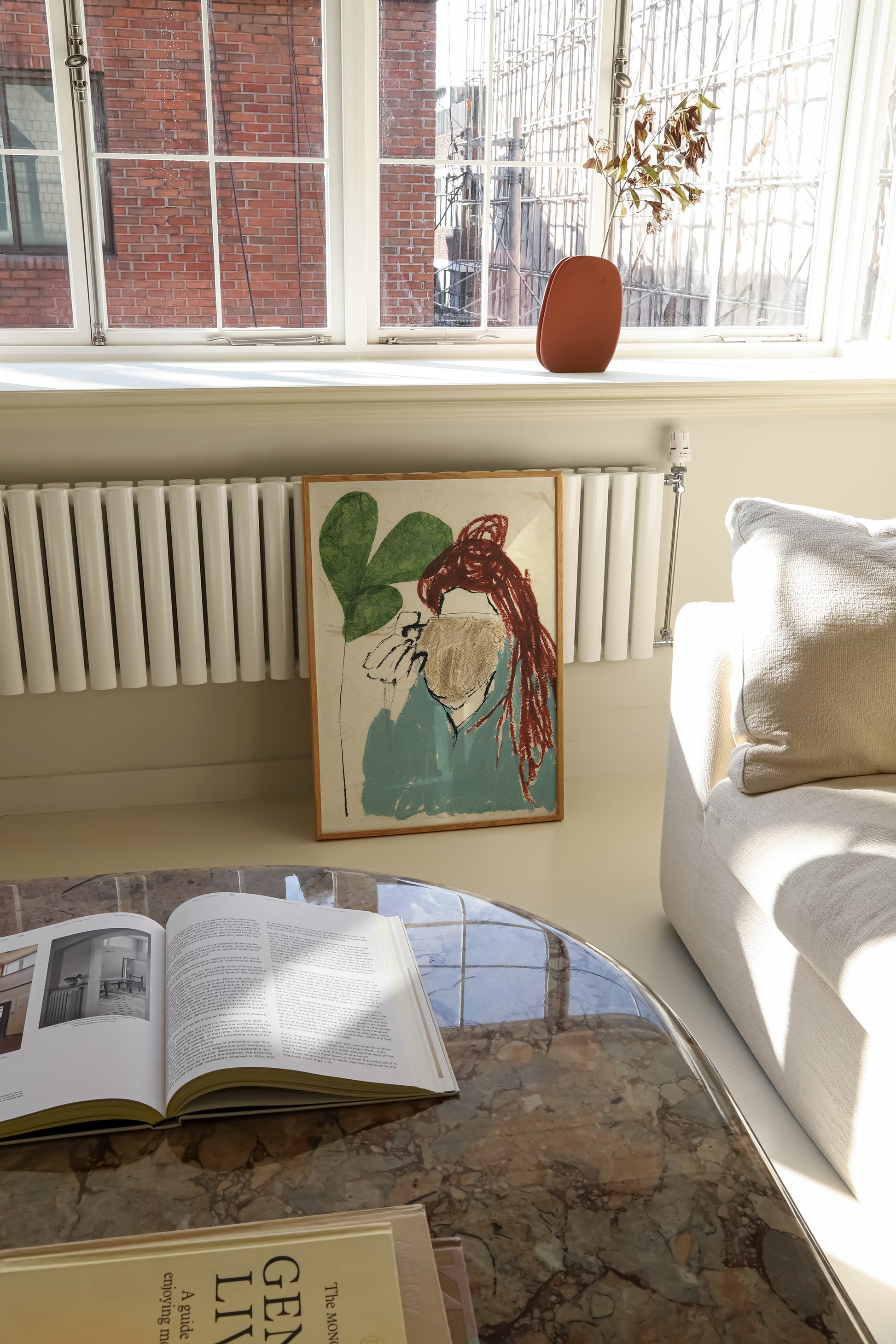 Framed Illustration of a girl wearing a blue top, drinking from a brown mug.