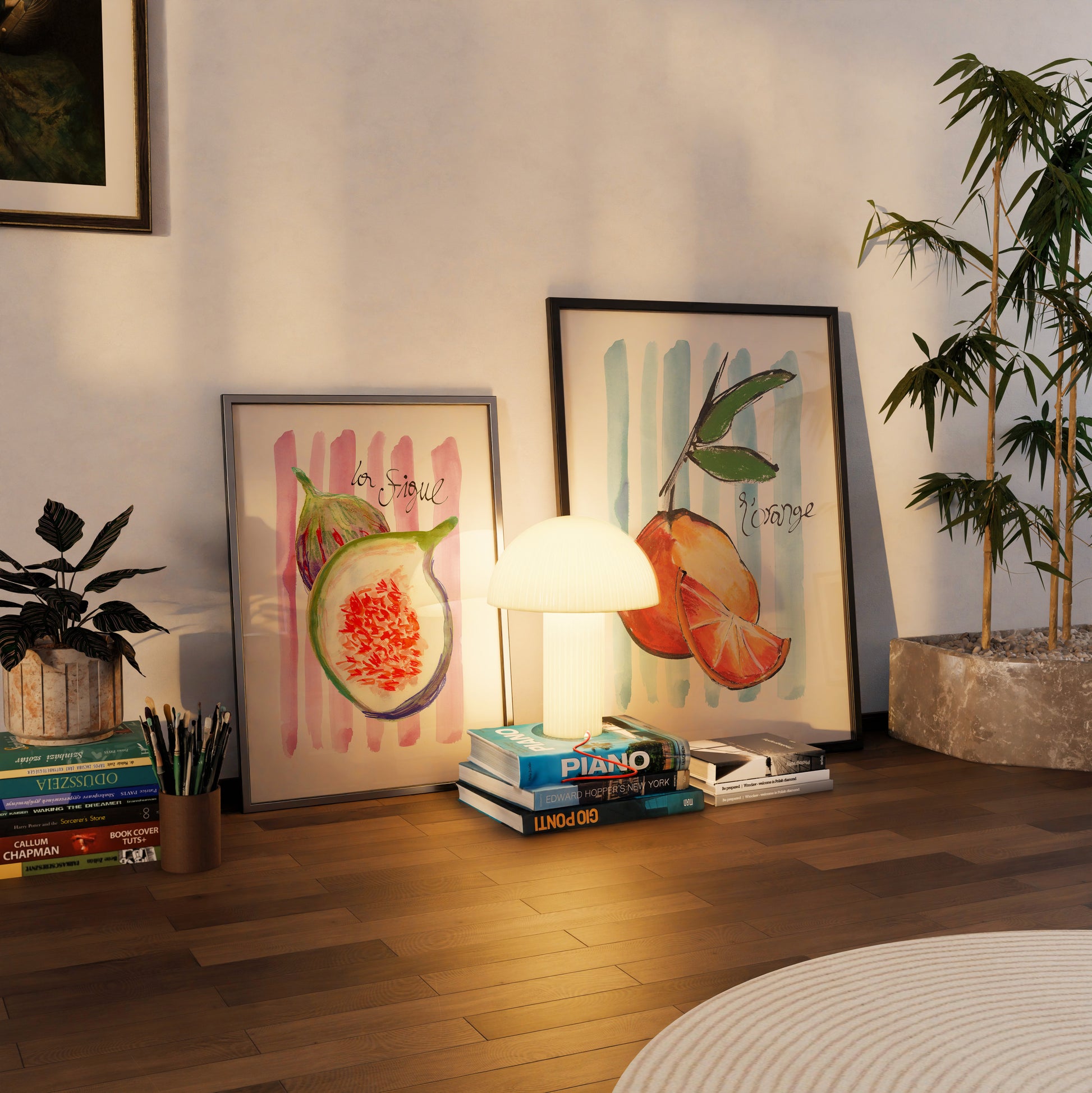 Room interior with books, a lamp, and framed artwork on a wooden floor.